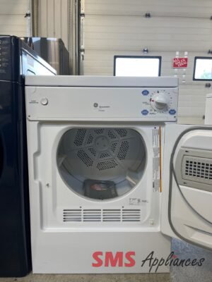 White GE Spacemaker front-load dryer with door open, drum visible, in an appliance showroom.