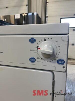 Front view of a white laundry appliance with a large circular control dial, blue setting stickers, and an 'SMS Appliances' logo partially visible at the bottom right.