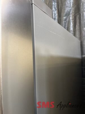 Close-up of a brushed stainless steel appliance corner with a seam and textured finish; partial 'SMS Appliances' logo visible.